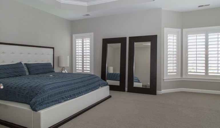White shutters in a minimalist bedroom in Atlanta.